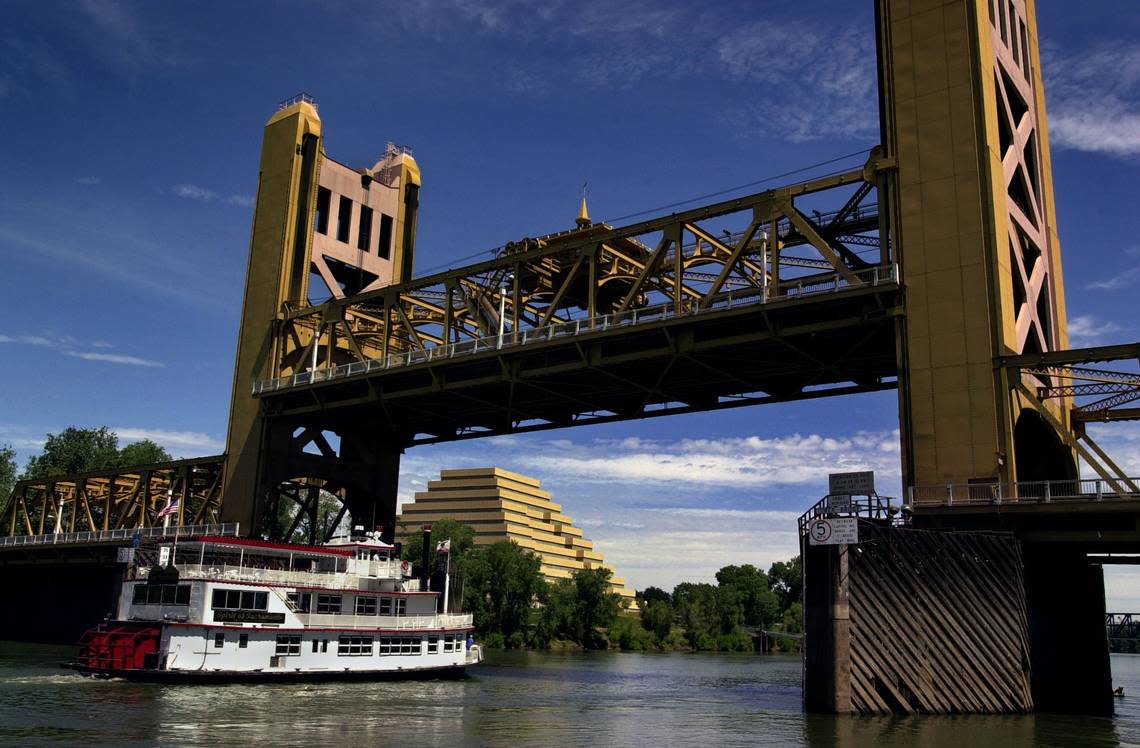 The Spirit of Sacramento, a paddle wheel boat replica, passes through the raised Tower Bridge on its way toward Old Sacramento on June 5, 2001.