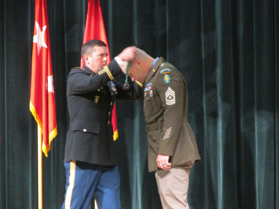 Sgt. Maj. Matthew Williams is welcomed by Lt. Col. Richard Woolshalger as a distinguished member of the special forces regiment during a Nov. 4, 2021, ceremony at Fort Bragg.