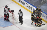 Chicago Blackhawks goalie Corey Crawford (50) waits as the Vegas Golden Knights celebrate a goal during the second period in Game 1 of an NHL hockey Stanley Cup first-round playoff series, Tuesday, Aug. 11, 2020, in Edmonton, Alberta. (Jason Franson/The Canadian Press via AP)