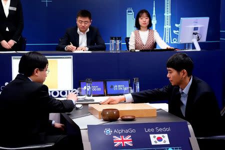 The worldÕs top Go player Lee Sedol (R) puts his first stone during the last match of the Google DeepMind Challenge Match against Google's artificial intelligence program AlphaGo in Seoul, South Korea, in this handout picture provided by Google and released by Yonhap on March 15, 2016. REUTERS/Google/Yonhap