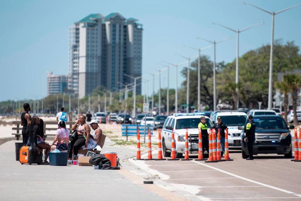 Spring breakers sit near Biloxi Beach in Biloxi during Black Spring Break on Saturday, April 13, 2024. Some attendees say they were bothered by the large police presence.