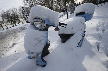 A snow covered scooter is seen in Chicago, Illinois, January 8, 2014. REUTERS/Jim Young