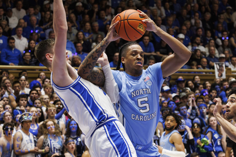 North Carolina's Armando Bacot (5) works in the post against Duke's Kyle Filipowski, left, during the first half of an NCAA college basketball game in Durham, N.C., Saturday, March 9, 2024. (AP Photo/Ben McKeown)