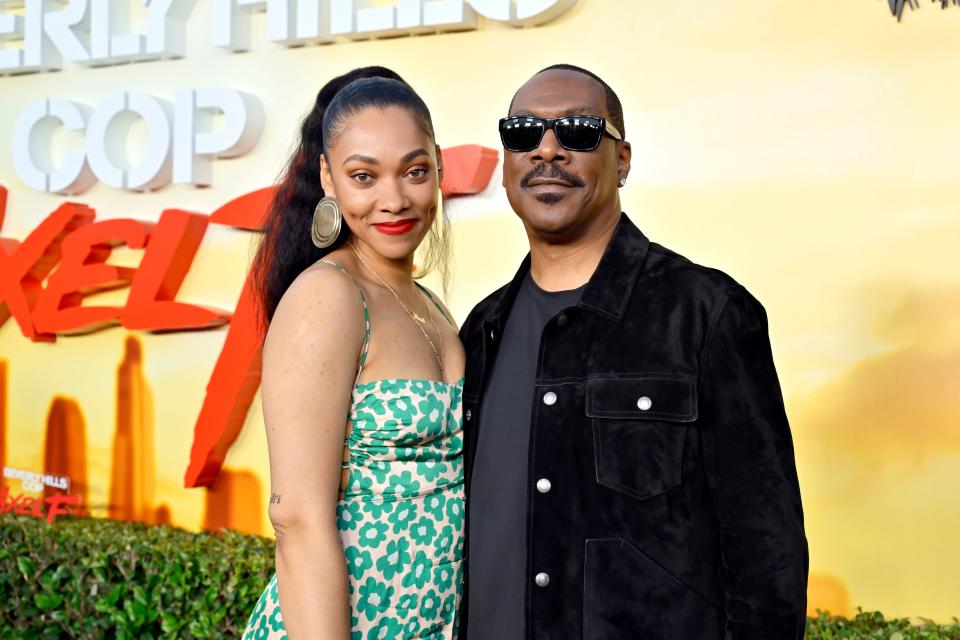 Bria Murphy standing next to Eddie Murphy