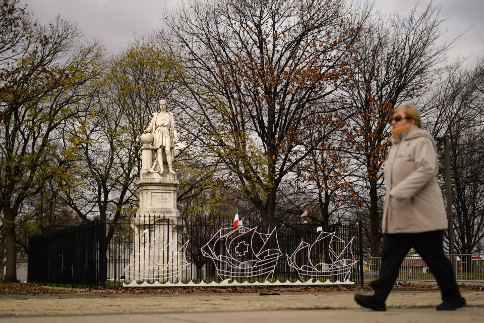 A person walks by the statue of Christopher Columbus at Marconi Plaza in Philadelphia, Monday, Dec. 12, 2022. Philadelphia removed the plywood box it placed over the statue after 2020 protests over racial injustice. (AP Photo/Matt Rourke)