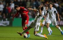 Liverpool's Iago Aspas (left) and Swansea City's Chico battle for the ball