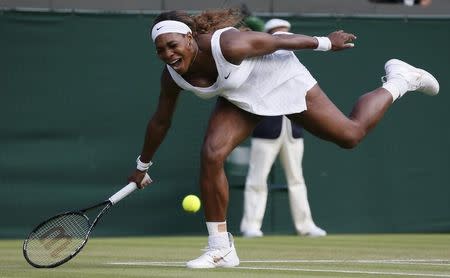 Serena Williams of the U.S. reacts as she fails to reach a shot during her women's singles tennis match against Alize Cornet of France at the Wimbledon Tennis Championships, in London June 28, 2014. REUTERS/Stefan Wermuth