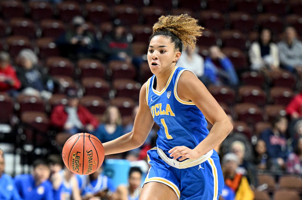 UCLA's Kiki Rice handles the ball against Florida State during the Women's Hall of Fame Showcase at Mohegan Sun Arena in Uncasville, Connecticut, on Dec. 10, 2023. (Photo by G Fiume/Getty Images)