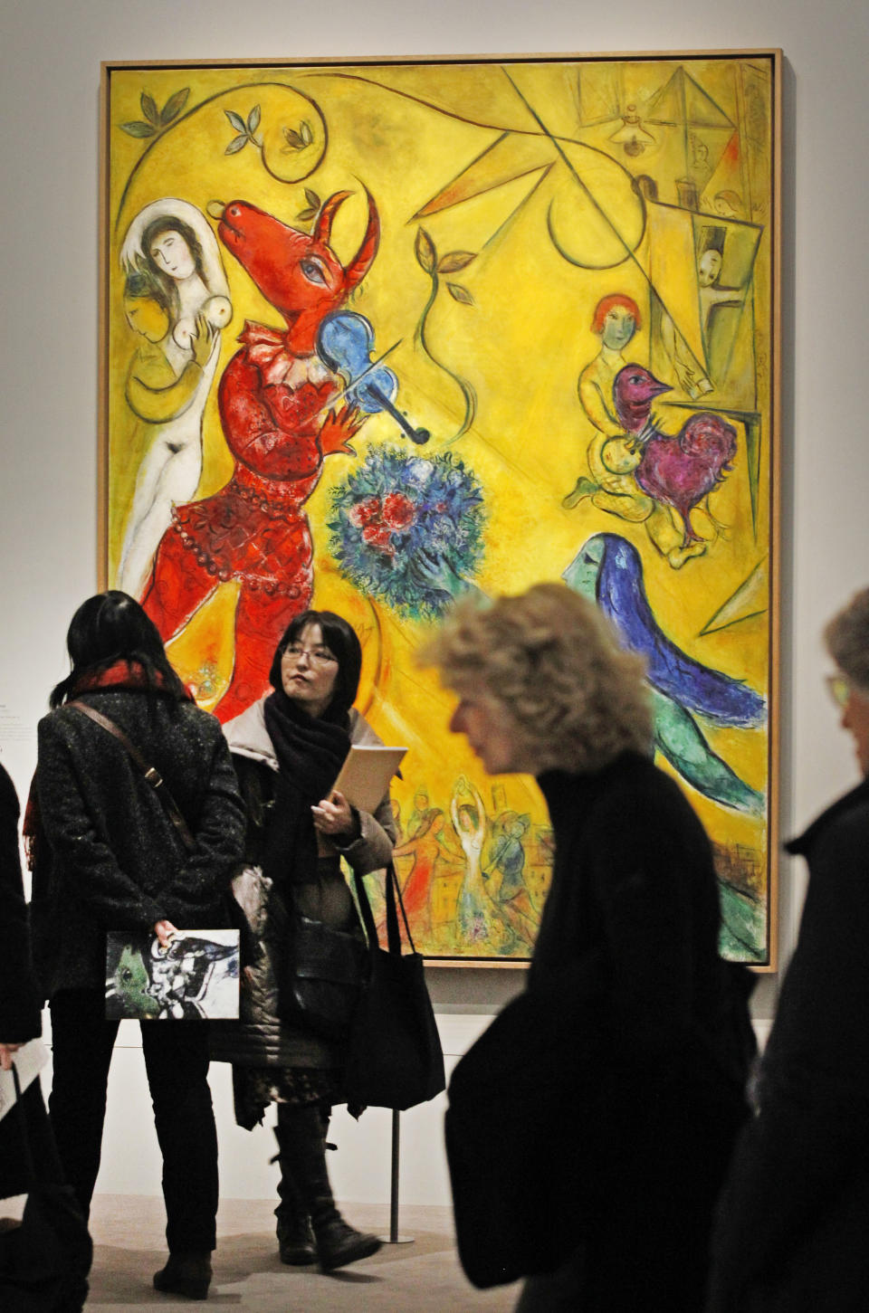 Members of the media stand in front of: La Danse, a 1952 painting by Russian artist Marc Chagall before the opening of the exhibition: Chagall, between War and Peace, at the Luxembourg museum in Paris, Tuesday Feb. 19, 2013. The exhibition starts February 21 and ends July 21, 2013.(AP Photo/Remy de la Mauviniere)