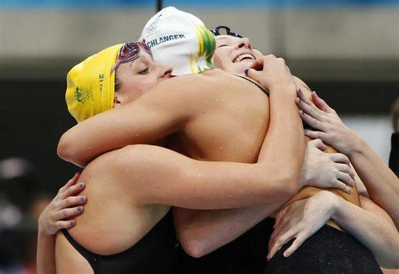 Members of the Australian women's 4x100m freestyle relay team celebrate after winning the event final at the London 2012 Olympic Games at the Aquatics Centre July 28, 2012. The Australian quartet of Alicia Coutts, Cate Campbell, Brittany Elmslie and Melanie Schlanger won gold in a combined time of three minutes, 33.15 seconds.