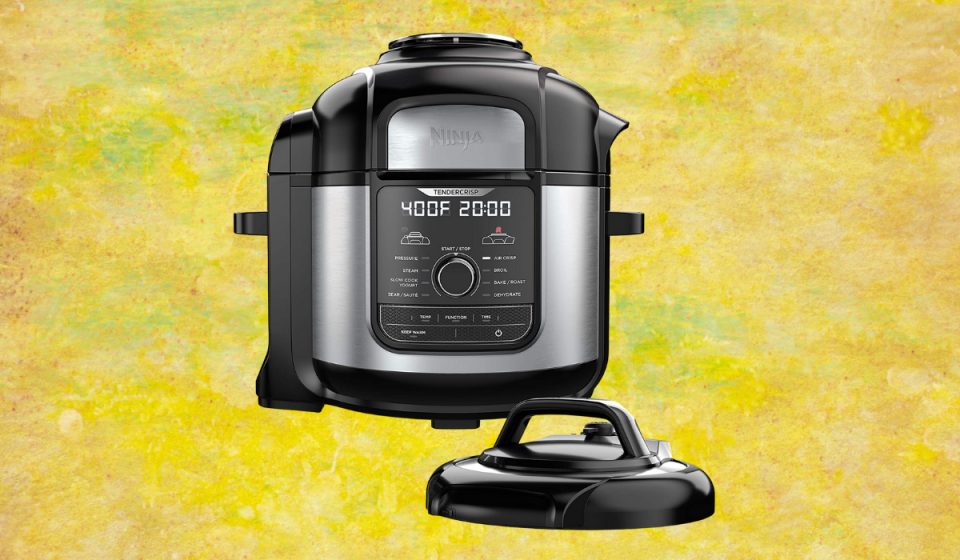 A black and silver air fryer/pressure cooker with black lid and LED screen on the front