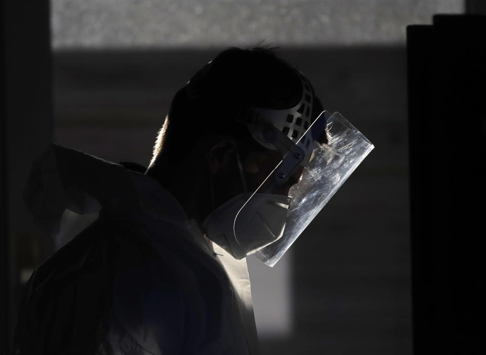 A healthcare worker at a sampling station for COVID-19 in Prague, Czech Republic, Monday, Sept. 21, 2020. The country coped well with the first wave of the coronavirus infections in the spring but has been facing a record surge of the new confirmed cases last week. (AP Photo/Petr David Josek)