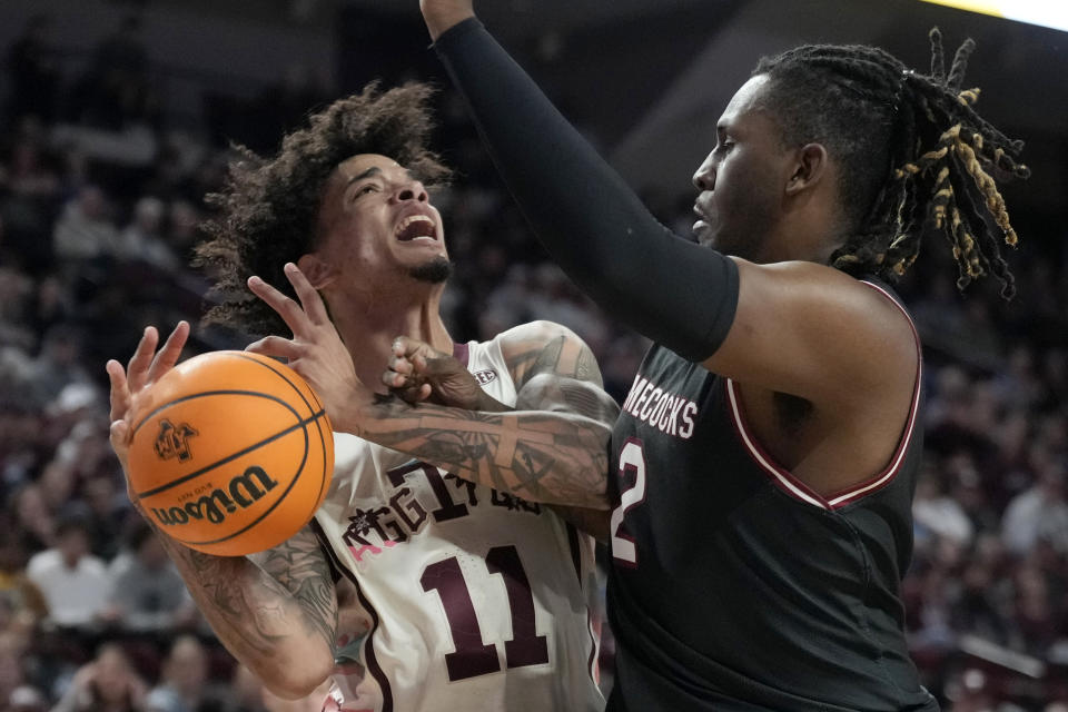 Texas A&M forward Andersson Garcia (11) is fouled by South Carolina forward B.J. Mack (2) while trying to pass the ball under the basket during the first half of an NCAA college basketball game Wednesday, Feb. 28, 2024, in College Station, Texas. (AP Photo/Sam Craft)