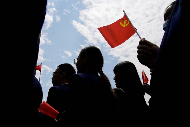 FILE PHOTO: People attend an event marking the 100th founding anniversary of the Communist Party of China, in Shanghai