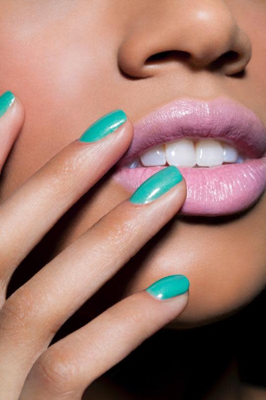 Female Hands With Long Nails And Neon Coral Orange Nail Polish