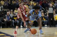 Wisconsin's Tyler Wahl knock the ball from Marquette's Olivier-Maxence Prosper during the overtime of an NCAA college basketball game Saturday, Dec. 3, 2022, in Milwaukee. Wisconsin won 80-77 in overtime. (AP Photo/Morry Gash)