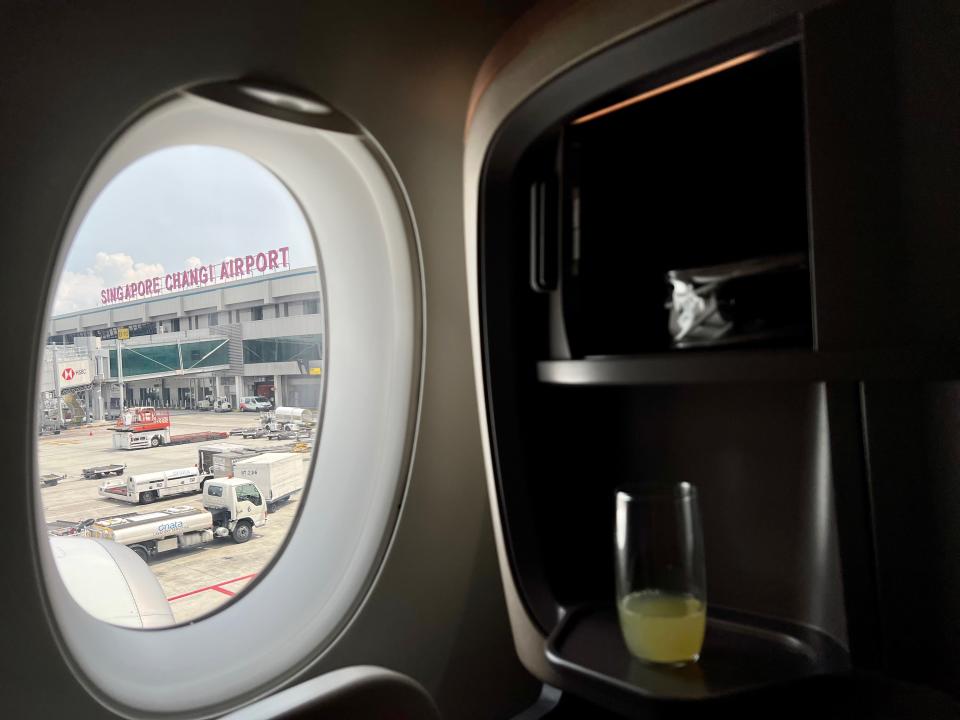 The Singapore airlines signage looking from inside the Singapore A350 window.