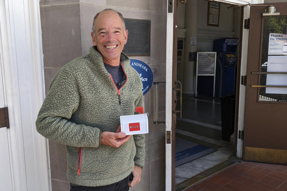 File - Netflix's first CEO, Marc Randolph, poses outside the Santa Cruz, California, post office in May, 2022, where he had mailed a Patsy Cline CD to the company's co-founder Reed Hastings, to test whether a disc could make it through the mail. The Netflix DVD-by-service will mail out its final discs Friday from its five remaining distribution centers, ending its 25-year history. (AP Photo/Mike Liedtke, File)