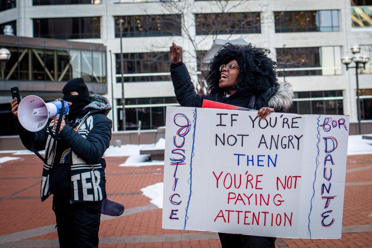 Ashley Dorelus (R) and Tanya James (L) demonstrate outside the Hennepin County Government Center in Minneapolis, Minn. on Dec. 23, 2021, during jury deliberations in the trial of former police officer Kim Potter.