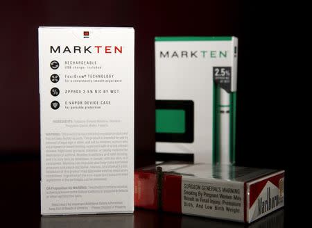 The packaging and health warnings for electronic MarkTen (left and rear) and Marlboro (lower right) tobacco cigarettes are seen in this photo illustration shot in Washington March 17, 2015. REUTERS/Gary Cameron