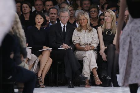 (L-R) French Culture Minister Fleur Pellerin, LVMH Chief Executive Bernard Arnault, his wife Helene and daughter Delphine attend the Raf Simons Spring/Summer 2015 women's ready-to-wear collection show for French fashion house Christian Dior during Paris Fashion Week September 26, 2014. REUTERS/Gonzalo Fuentes