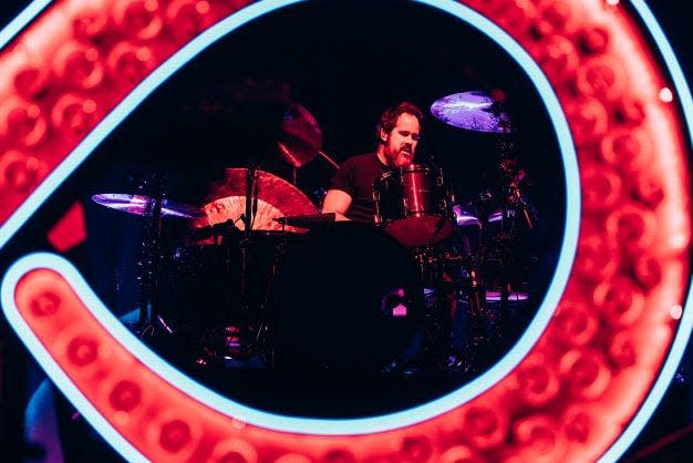 The Killers drummer Ronnie Vannucci Jr. seen through the band's infinity symbol-shaped keyboards.