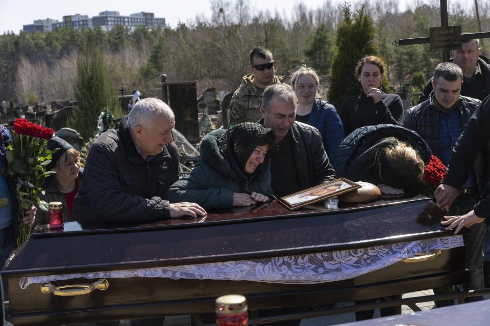 Relatives mourn the dead of Oleksandr Mozheiko, 31, territorial defense soldier who was killed by Russian army on March 5, during his funeral Friday in Irpin, Ukraine.