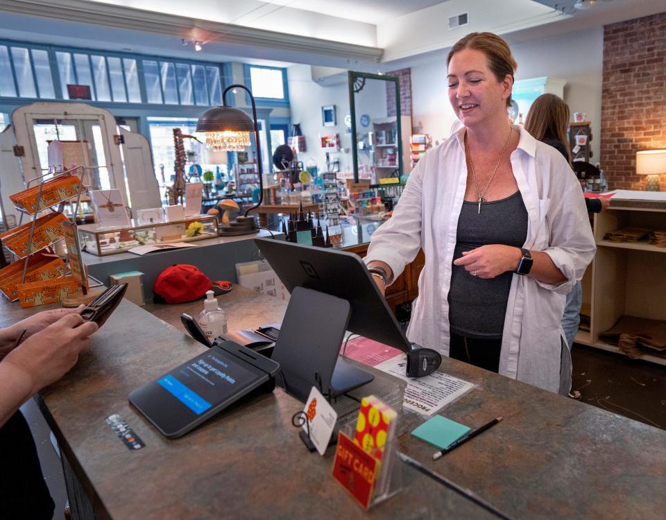 Susan Truitt checks out a customer in her family-owned business, The Bungalow Inc., Wednesday, June 28, 2023 in Broad Ripple. B-link cameras are a new public safety measure that connects cameras to IMPD’s Incident Analysis Center. The Bungalow Inc. is one company that uses the cameras. 