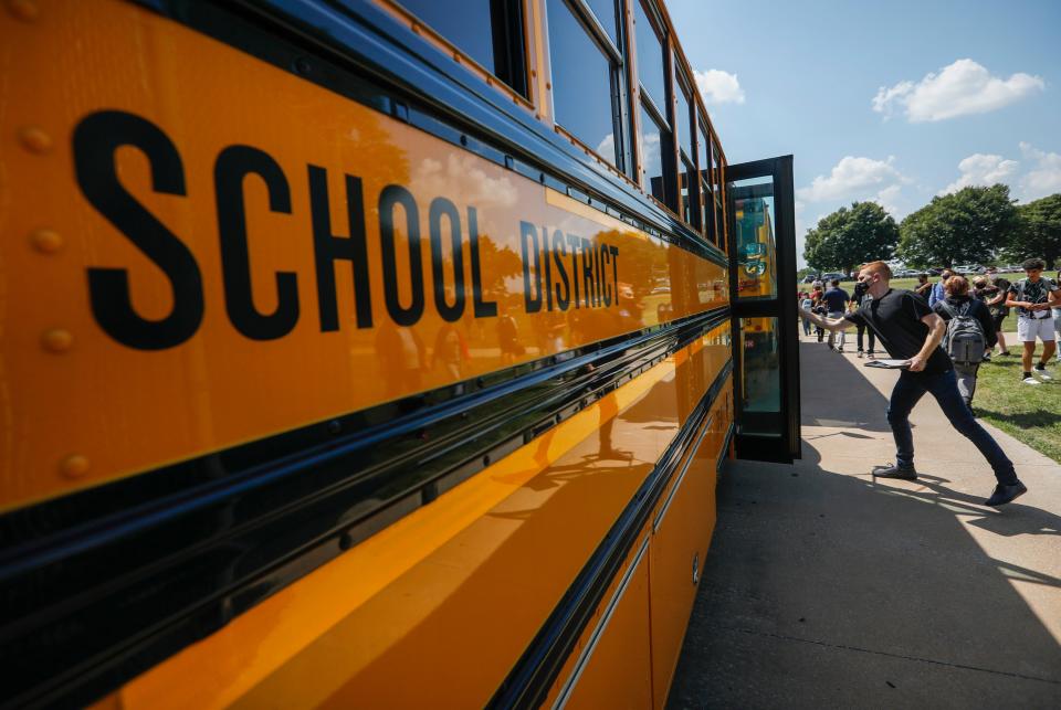 Josiah Majerus, who plans bus routes but is chipping in to drive a bus, shuts the door to the bus at the end of the day at Parkview High School on Thursday, Aug. 27, 2021.