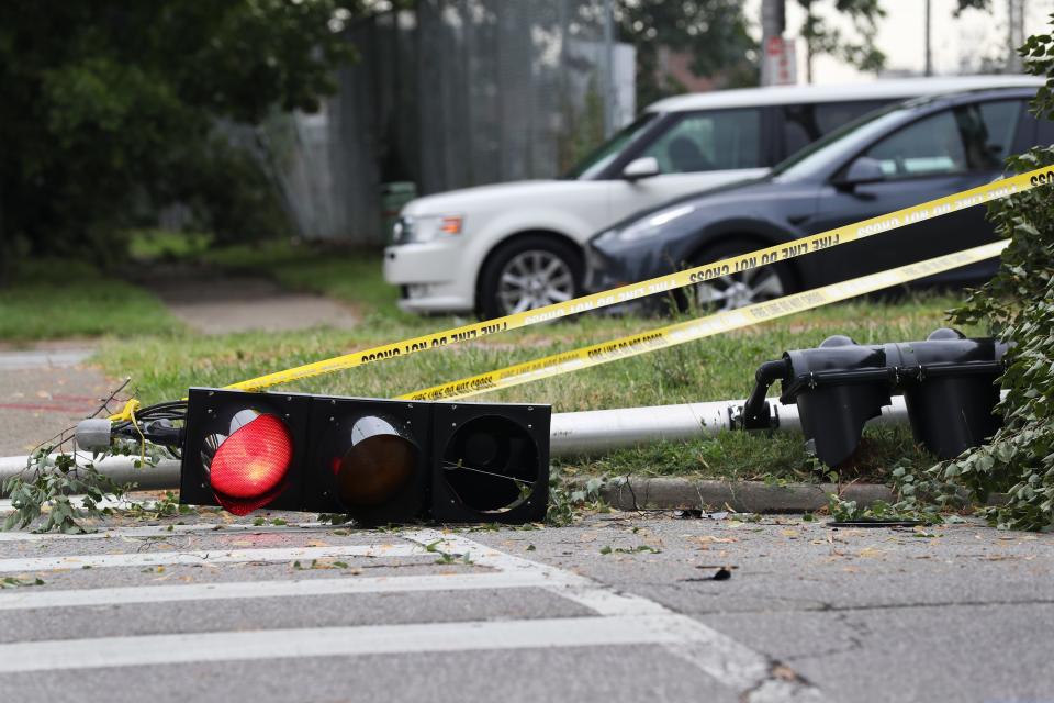 A traffic light was wrapped in caution tape at the intersection of Muhammad Ali Boulevard and Roy Wilkins Avenue after it fell during a storm that moved through Louisville, Ky., on July 6, 2022.