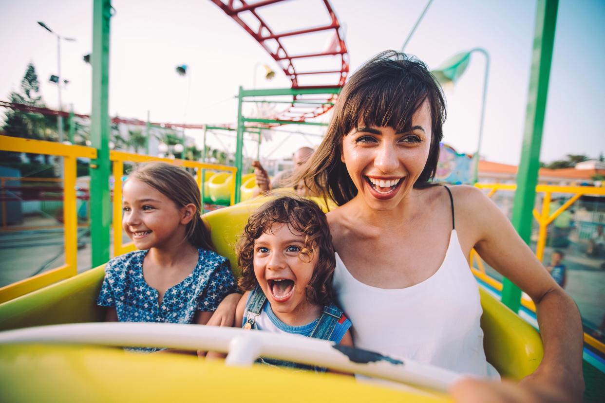 Mom and her two children riding a rollercoaster