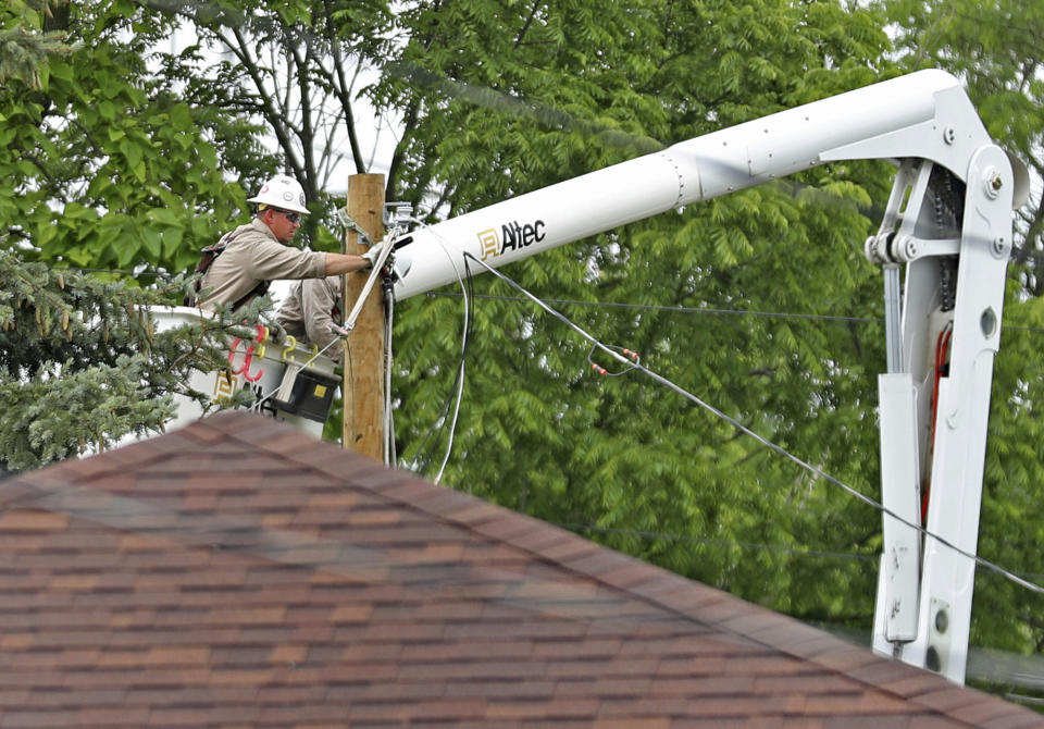 This Sunday, June 16, 2019, photo power lines were checked in Beech Grove, Ind., after a tornado moved through the area. Weather officials say severe storms in central Indiana caused floods and produced several tornadoes. (Kelly Wilkinson/The Indianapolis Star via AP)