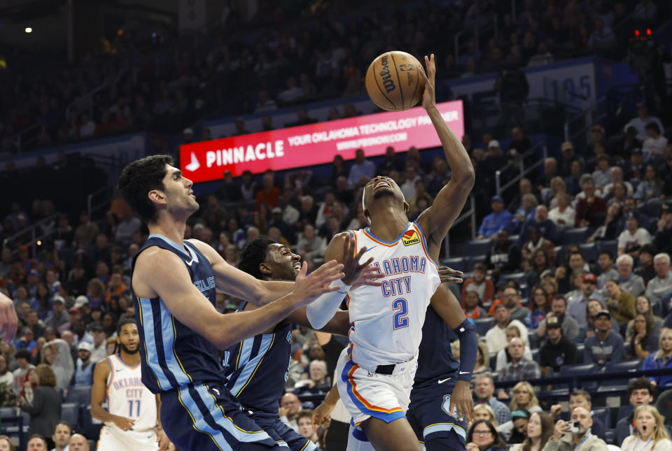 Dec 18, 2023; Oklahoma City, Oklahoma, USA; Oklahoma City Thunder guard Shai Gilgeous-Alexander (2) is fouled by Memphis Grizzlies forward <a class="link " href="https://sports.yahoo.com/nba/players/6572" data-i13n="sec:content-canvas;subsec:anchor_text;elm:context_link" data-ylk="slk:Santi Aldama;sec:content-canvas;subsec:anchor_text;elm:context_link;itc:0">Santi Aldama</a> (7) during the second quarter at Paycom Center. Mandatory Credit: Alonzo Adams-USA TODAY Sports