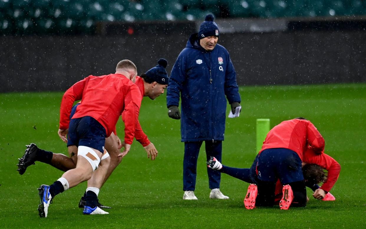 England head coach Eddie Jones (centre) observes his players during a training session at Twickenham Stadium - PA