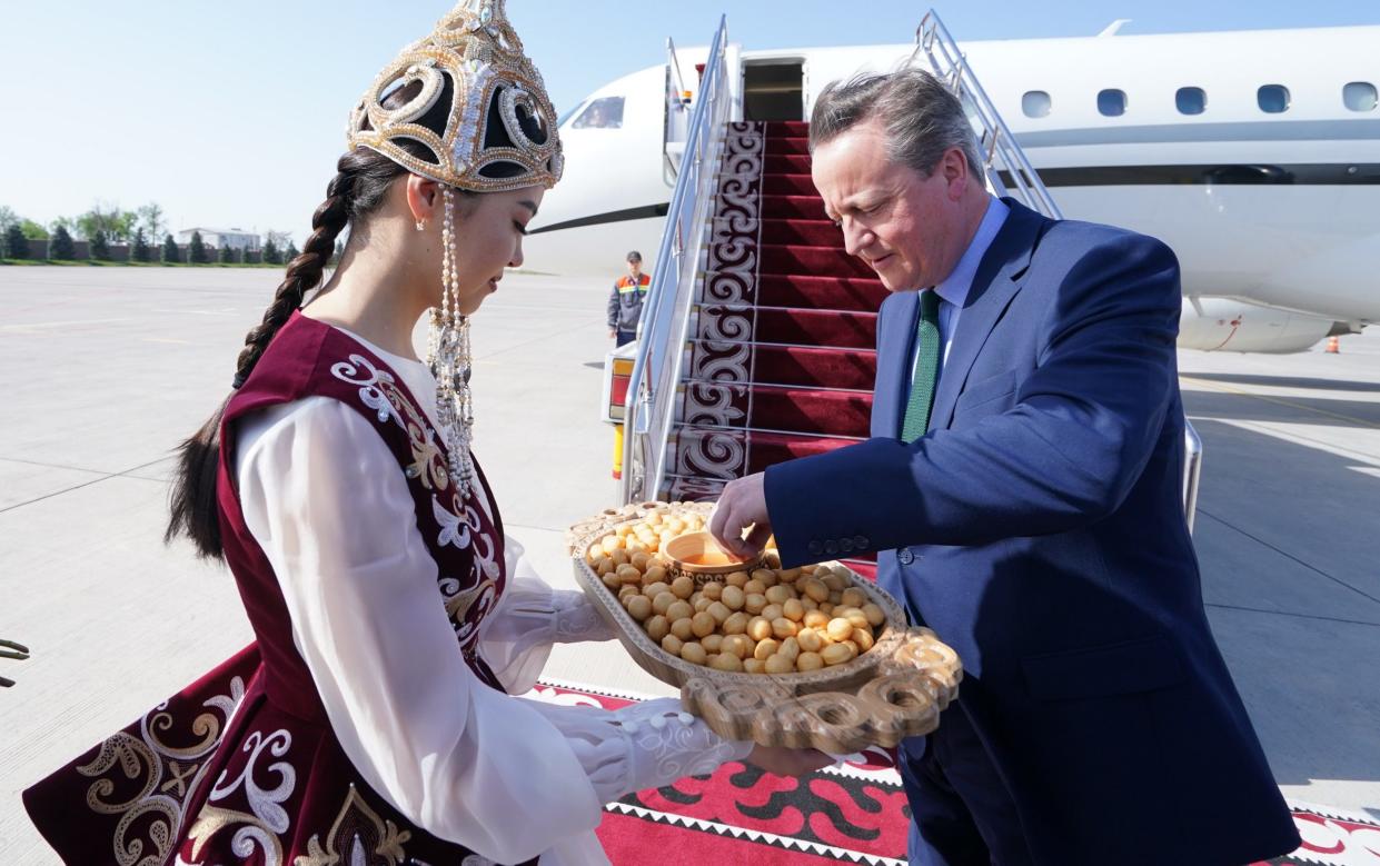 The Foreign Secretary samples a local delicacy as he steps off his plane at Bishek airport in Kyrgyzstan