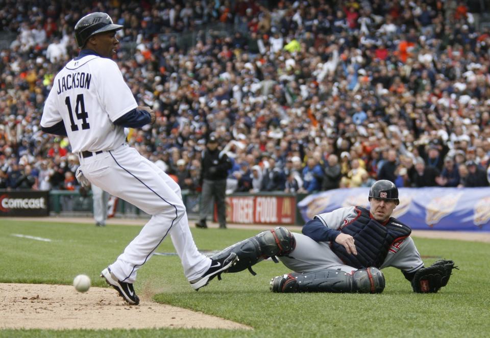 Detroit Tigers Austin Jackson was the last runner to score with the bases loaded as  Cleveland catcher Mike Redmond can't handle a wide throw to home plate in the 5th inning in Detroit on Friday, April 9, 2010. The Tigers scored three runs for a 4-2 lead on a Cleveland error by 3rd baseman Jhonny Peralta on a ball hit by Magglio Ordonez, who ended up at 2nd on the play.