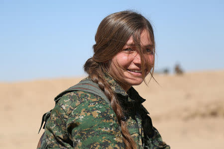 A Syrian Democratic Forces (SDF) female fighter poses in northern Deir al-Zor province, Syria February 21, 2017. REUTERS/Rodi Said