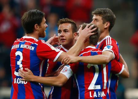 Bayern Munich&#39;s Xabi Alonso, Mario Goetze, Philipp Lahm and Thomas Mueller (L-R) celebrate after Goetze scored a goal against Paderborn during their German first division Bundesliga match in Munich September 23, 2014. REUTERS/Michael Dalder