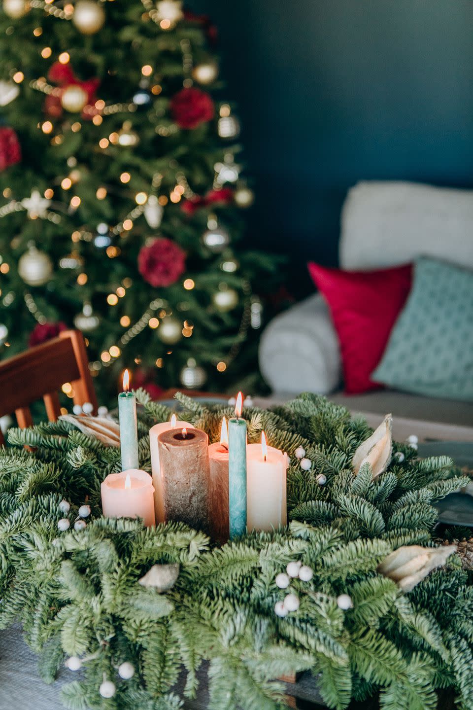 festive decorations and table setting inside the room with the christmas tree and garlands