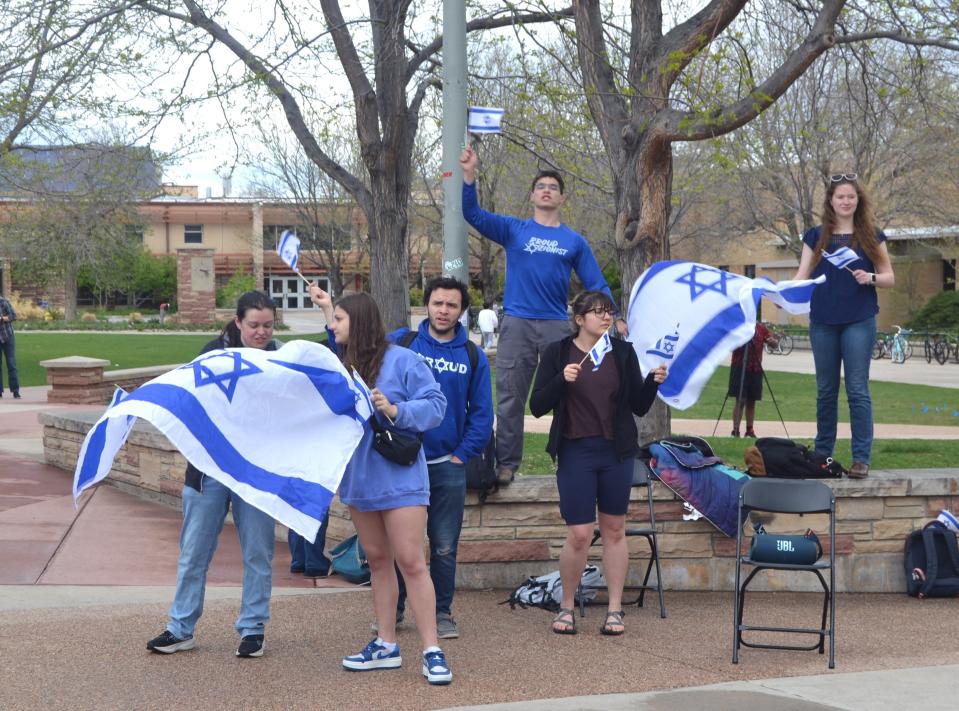 A small group of counter-protesters waive Israeli flags in the direction of pro-Palestinian protesters Wednesday, May 1, 2024, on the 'free speech plaza' outside Colorado State University's Lory Student Center in Fort Collins.
