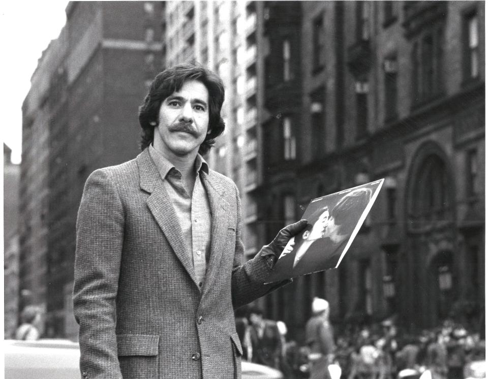 Geraldo Rivera holding a John Lennon album outside of the Dakota, the building where Lennon lived — and was murdered in front of in 1980. (Photo: Fox Nation)