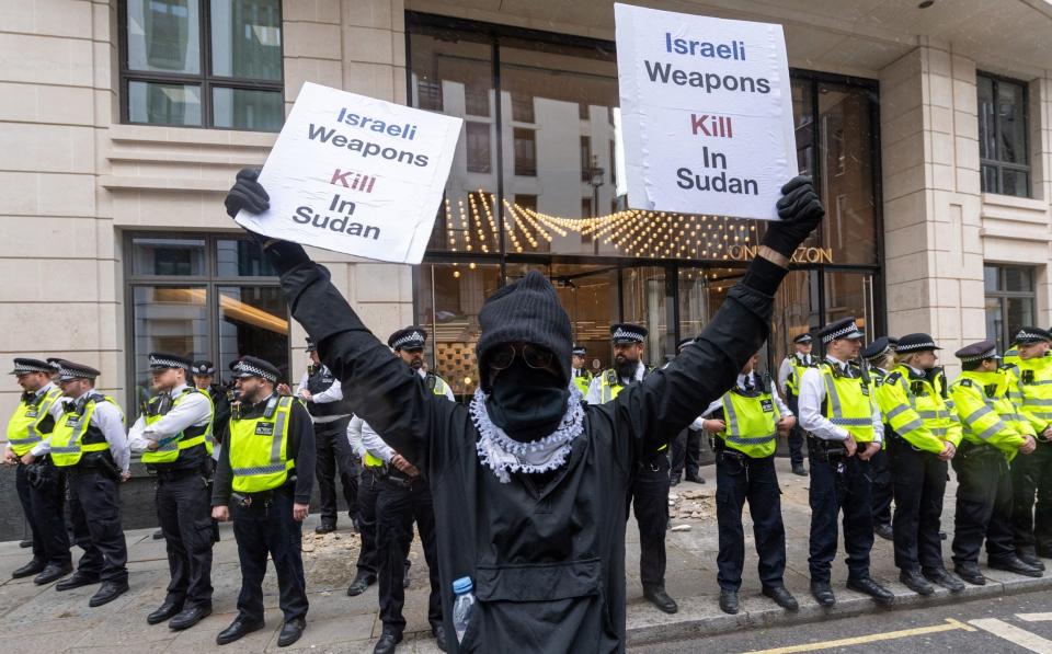 A masked protester spreads his message