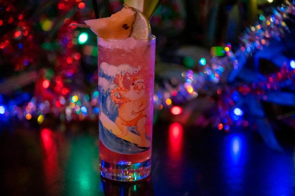 Midtown Sacramento tiki bar Jungle Bird’s holiday-themed “Jingle Bird” drink, made with bourbon, pineapple rum, Campari, and lime pineapple juices, sits on a table decorated for the holidays Tuesday. Lezlie Sterling/lsterling@sacbee.com