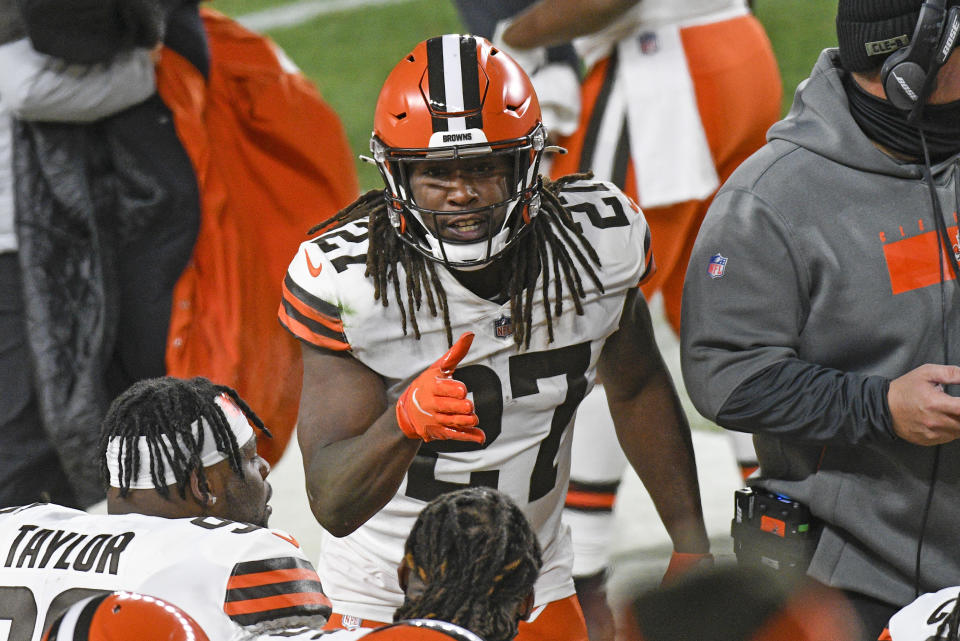 Cleveland Browns running back Kareem Hunt (27) celebrates as he returns to the sideline after scoring on an eight-yard run during the first half of an NFL wild-card playoff football game against the Pittsburgh Steelers in Pittsburgh, Sunday, Jan. 10, 2021. (AP Photo/Don Wright)