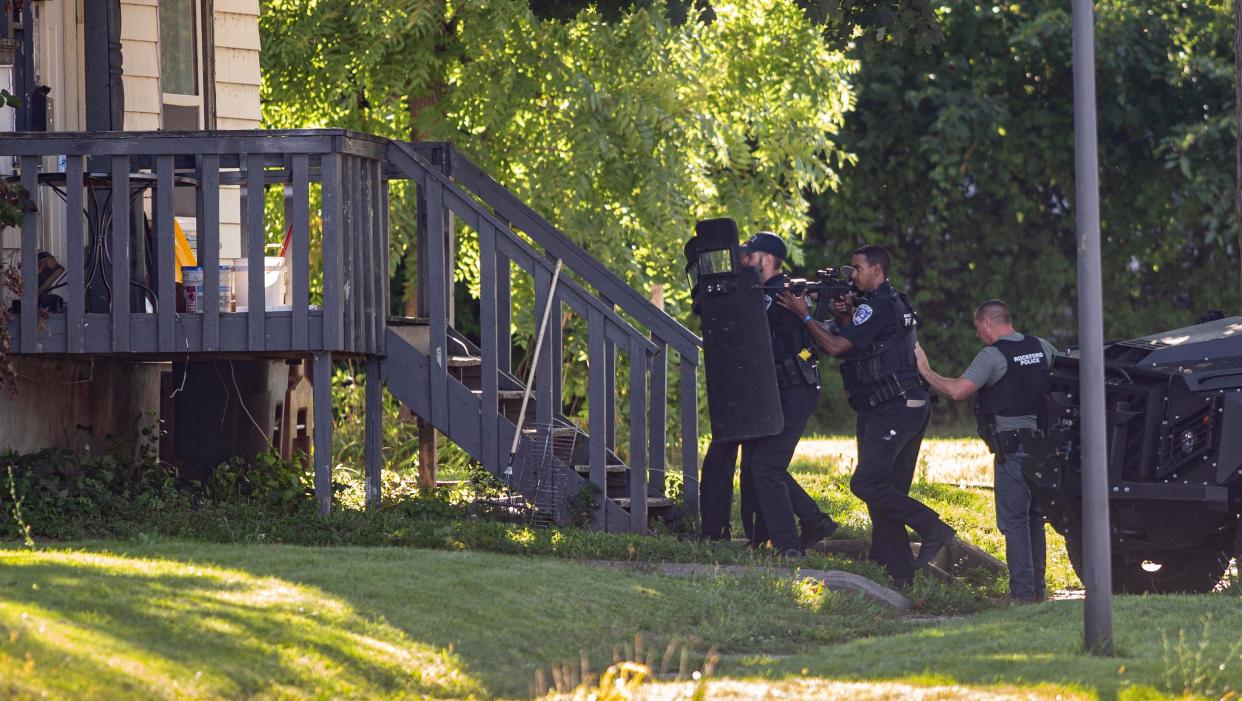 Rockford police officers line up outside of a home on the 300 block of South Fourth Street where a barricaded man was a suspect in a double shooting on Tuesday, Aug. 16, 2022, in Rockford.