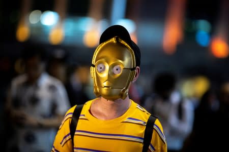 An anti-government protester wearing a mask of Star Wars character C-3PO is seen during a demonstration to celebrate Taiwan's National Day at Harbour City in Tsim Sha Tsui district, in Hong Kong