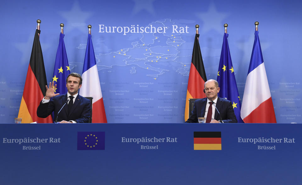 German Chancellor Olaf Scholz, right, and French President Emmanuel Macron address a media conference at the conclusion of an EU Summit in Brussels, Friday, Dec. 17, 2021. European Union leaders met for a one-day summit Thursday focusing on Russia's military threat to neighbouring Ukraine and on ways to deal with the continuing COVID-19 crisis. (John Thys, Pool Photo via AP)