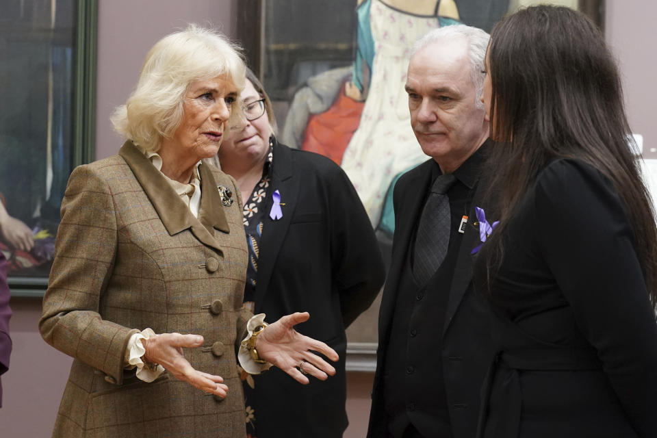 Britain's Queen Camilla, left, opens the new 'Safe Space' during a visit to Aberdeen Art Gallery, as part of an initiative to provide help and guidance to people if they suspect someone is living with domestic abuse, in Aberdeen, Scotland, Thursday Jan. 18, 2024. (Andrew Milligan/PA via AP)