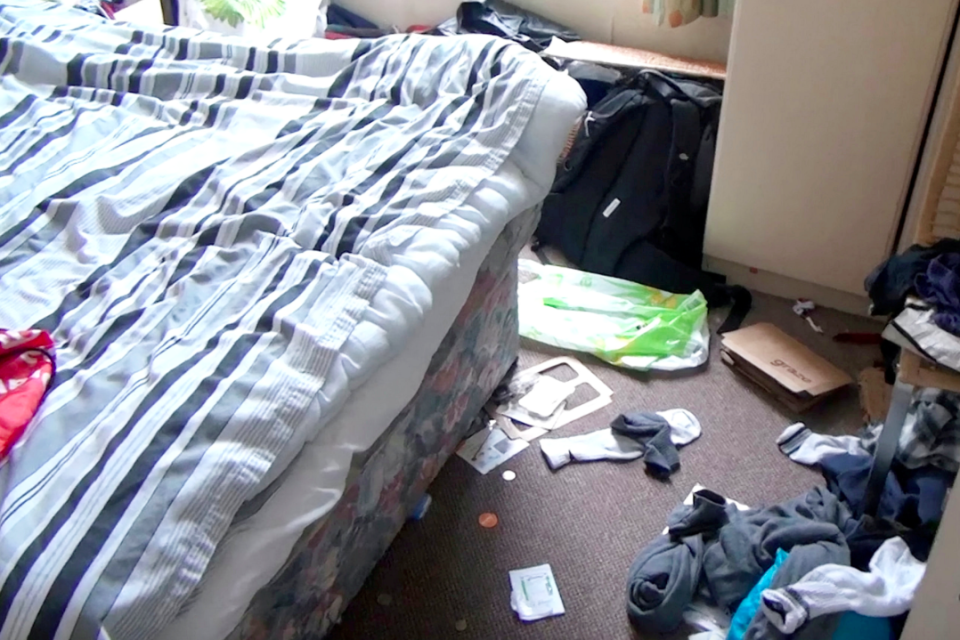 <em>Footage shot inside Falder’s pokey flat shows clothes, food containers and socks strewn over the floor – as well as a roll of toilet paper on his bed (SWNS)</em>