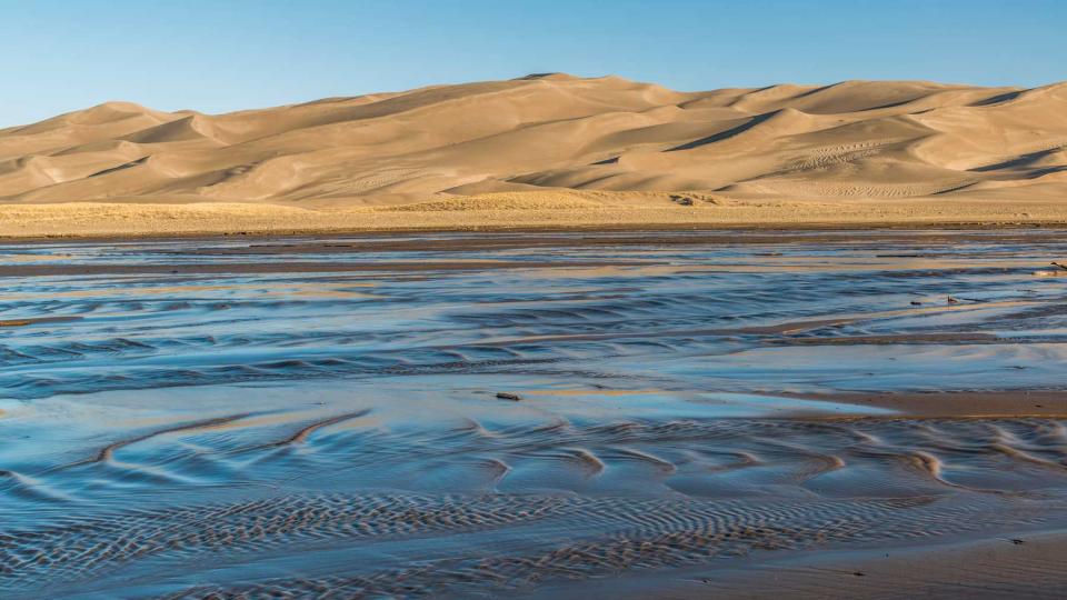 Sand dunes and Medano Creek at sunrise, Great Sand Dunes National Park, Colorado